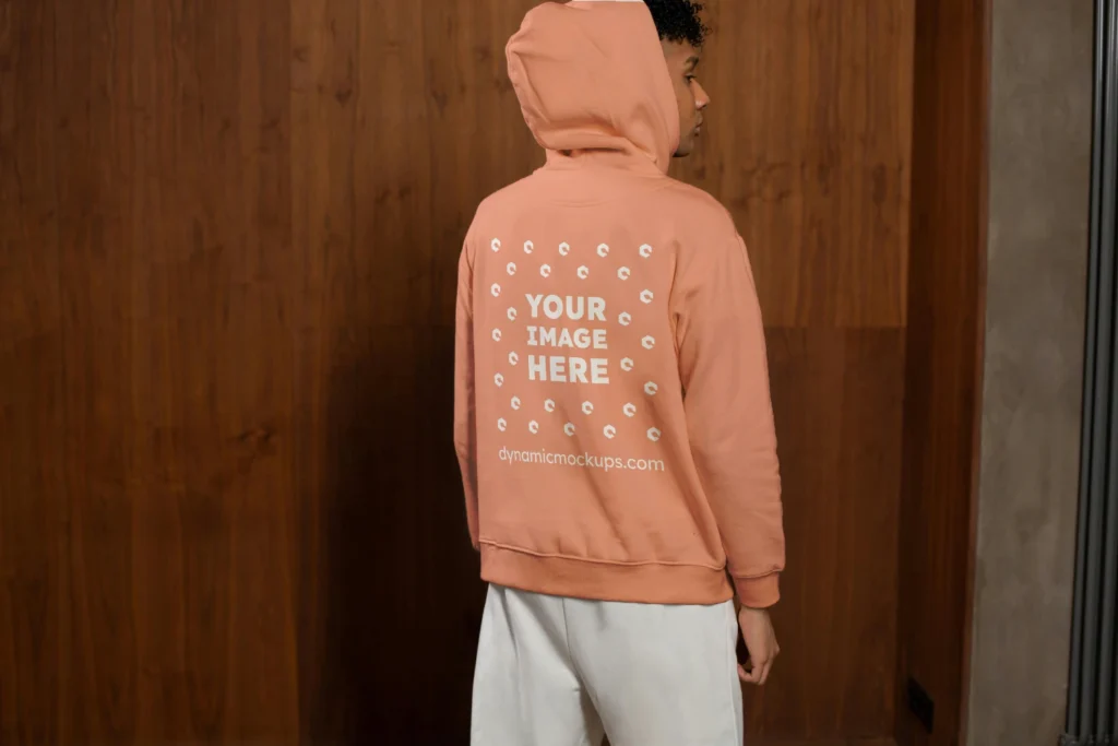 Man Wearing Peach Hoodie Mockup Back View Template