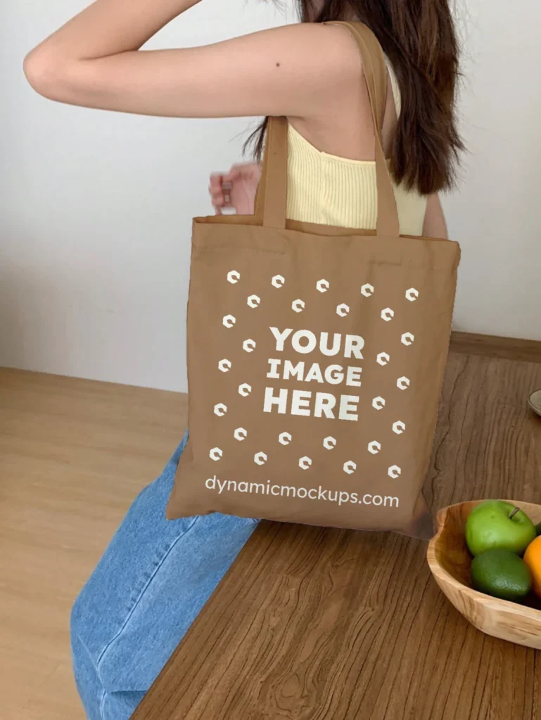 Woman Holding Brown Tote Bag Mockup Side View Template