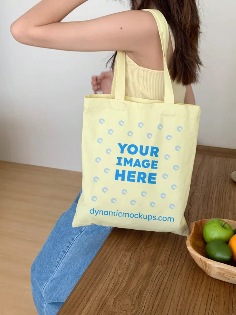 Woman Holding Cream Tote Bag Mockup Side View Template