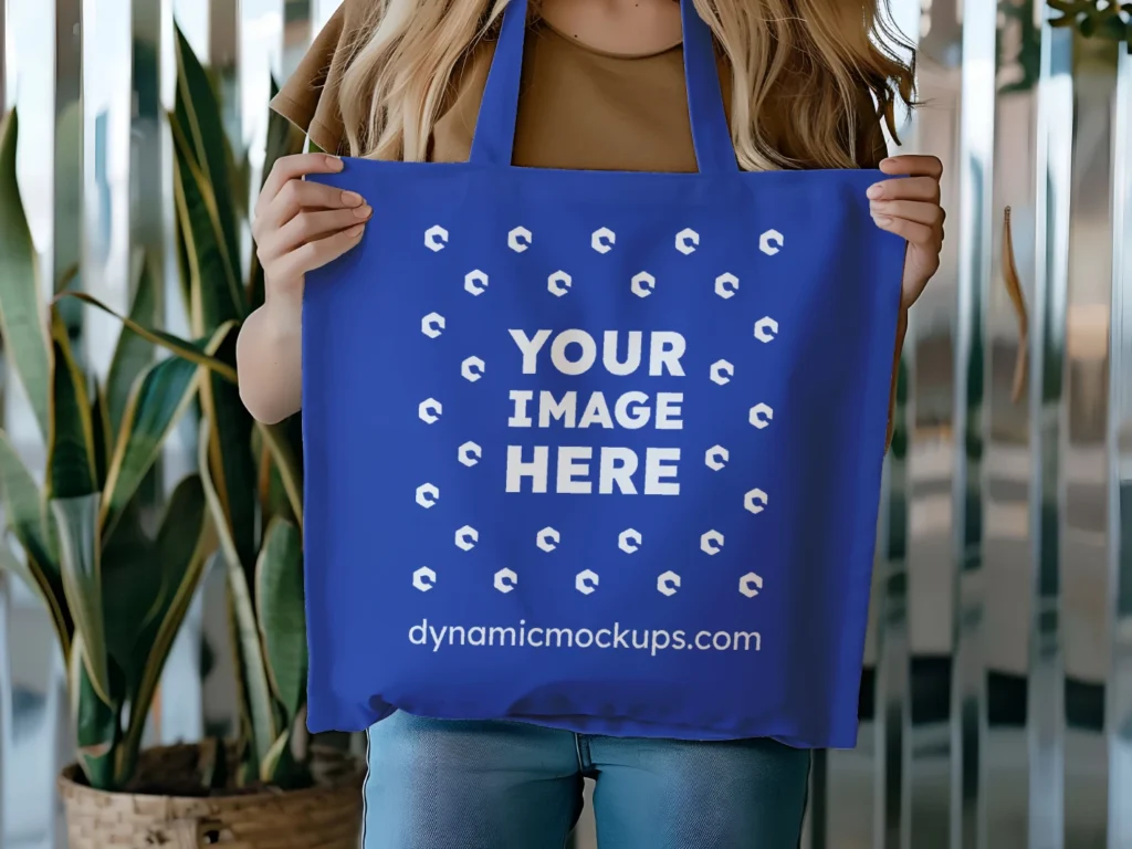 Woman Holding Dark Blue Tote Bag Mockup Front View Template