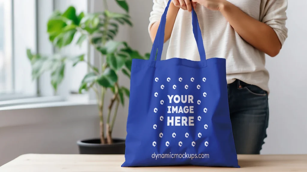 Woman Holding Dark Blue Tote Bag Mockup Front View Template