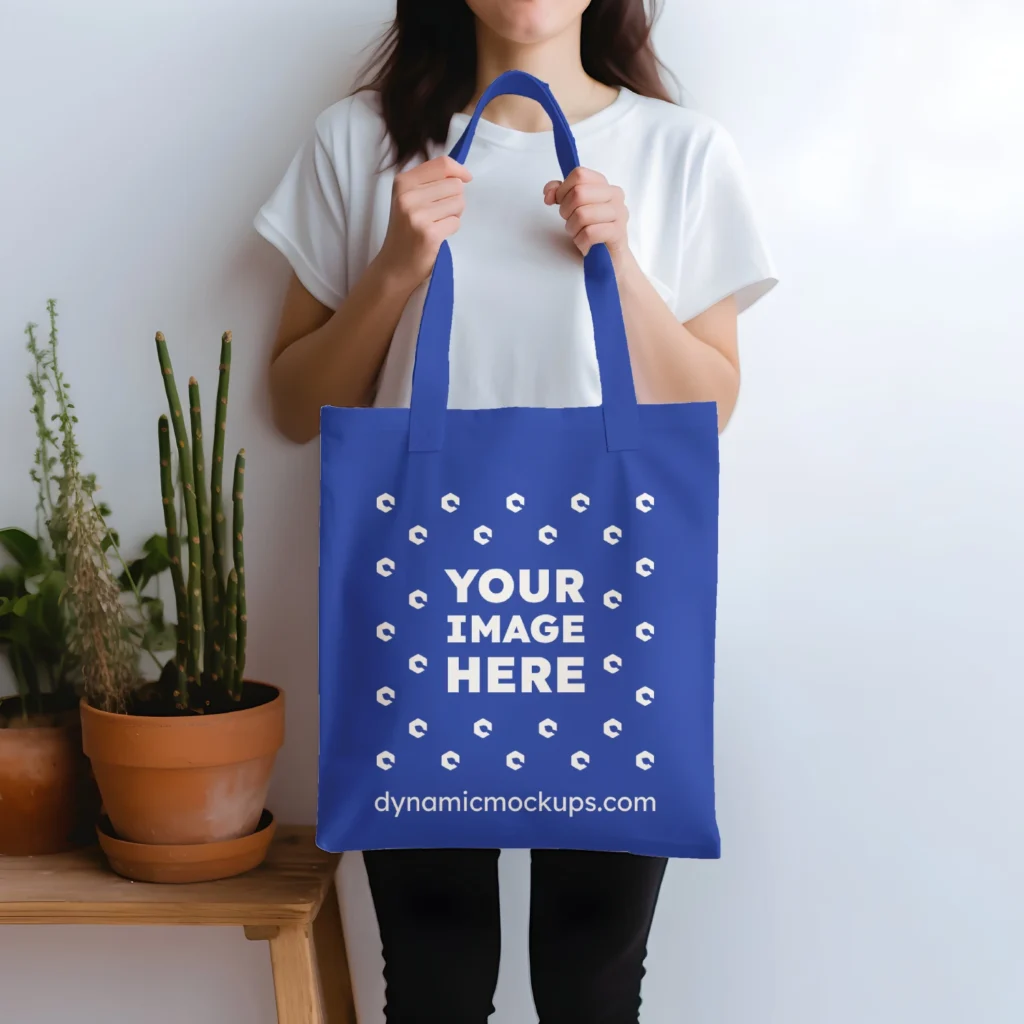 Woman Holding Dark Blue Tote Bag Mockup Front View Template