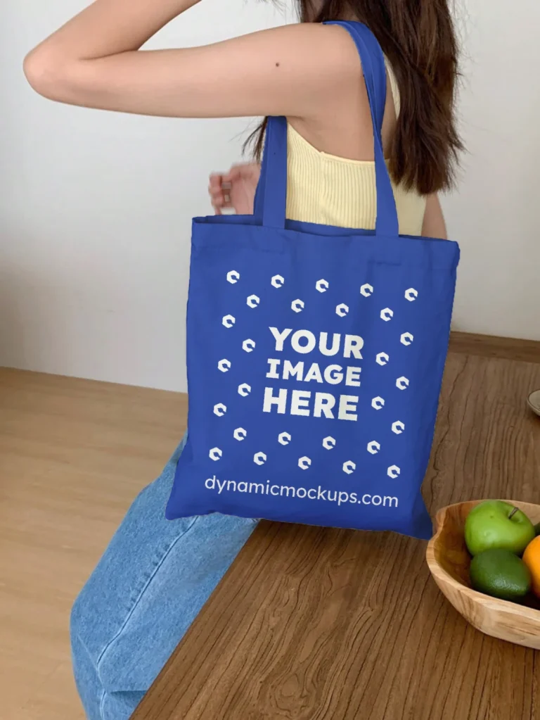 Woman Holding Dark Blue Tote Bag Mockup Side View Template