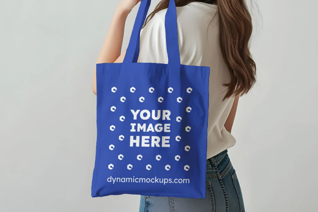 Woman Holding Dark Blue Tote Bag Mockup Side View Template