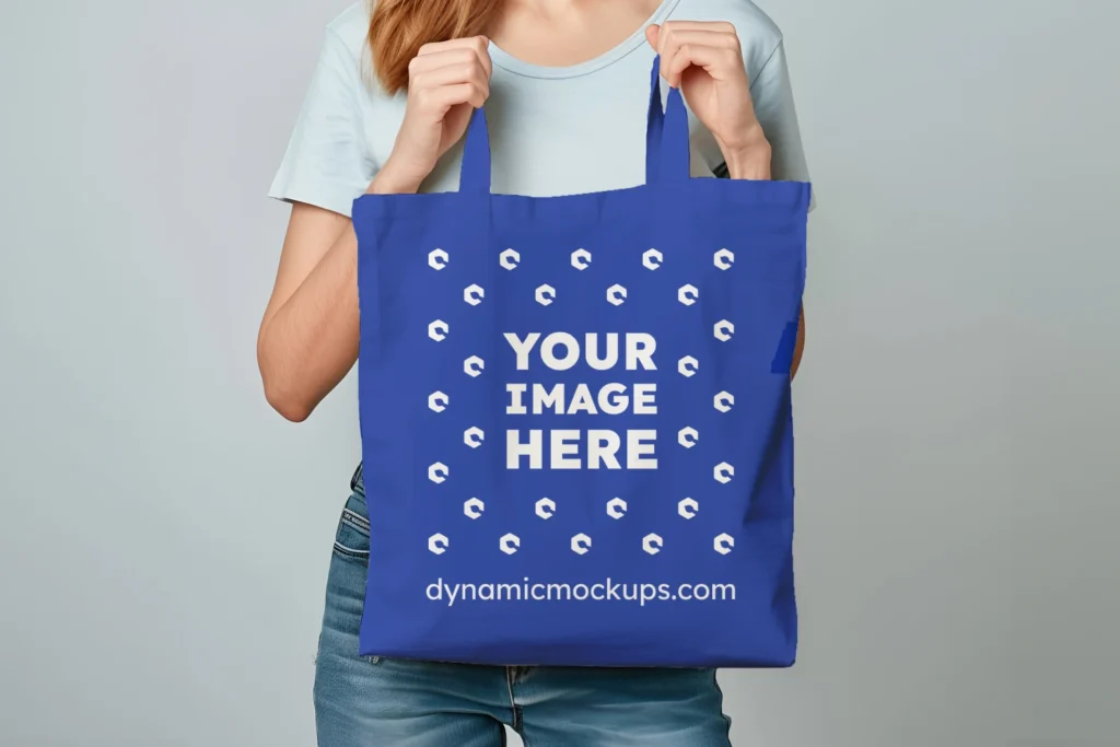 Woman Holding Dark Blue Tote Bag Mockup Front View Template