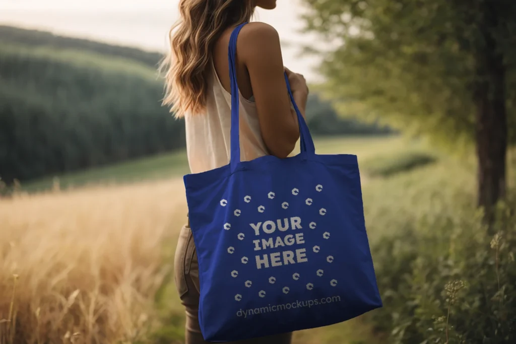 Woman Holding Dark Blue Tote Bag Mockup Side View Template