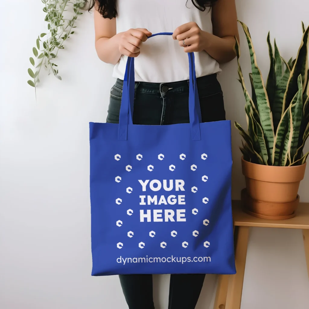 Woman Holding Dark Blue Tote Bag Mockup Front View Template