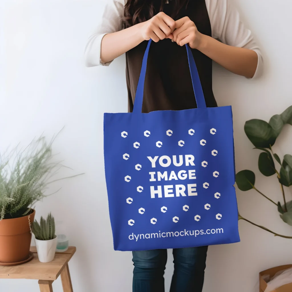 Woman Holding Dark Blue Tote Bag Mockup Front View Template