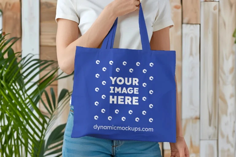 Woman Holding Dark Blue Tote Bag Mockup Front View Template