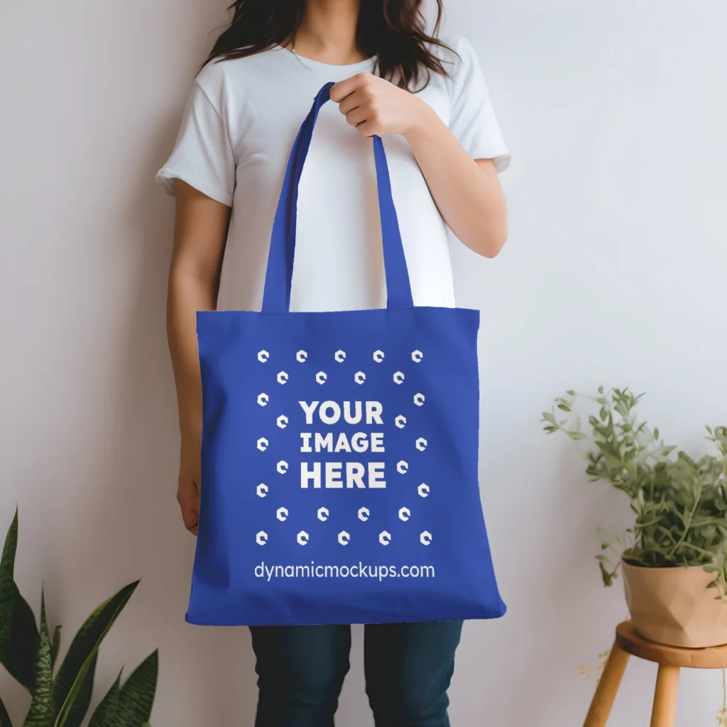 Woman Holding Dark Blue Tote Bag Mockup Front View Template