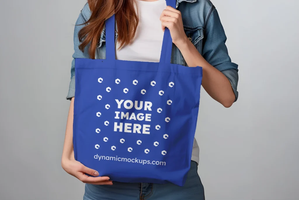 Woman Holding Dark Blue Tote Bag Mockup Front View Template