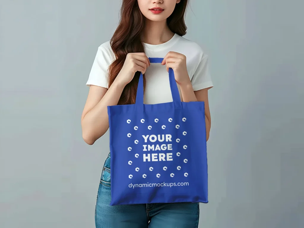 Woman Holding Dark Blue Tote Bag Mockup Front View Template