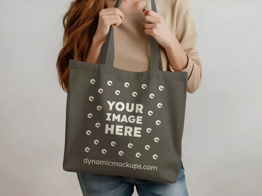 Woman Holding Dark Gray Tote Bag Mockup Front View Template