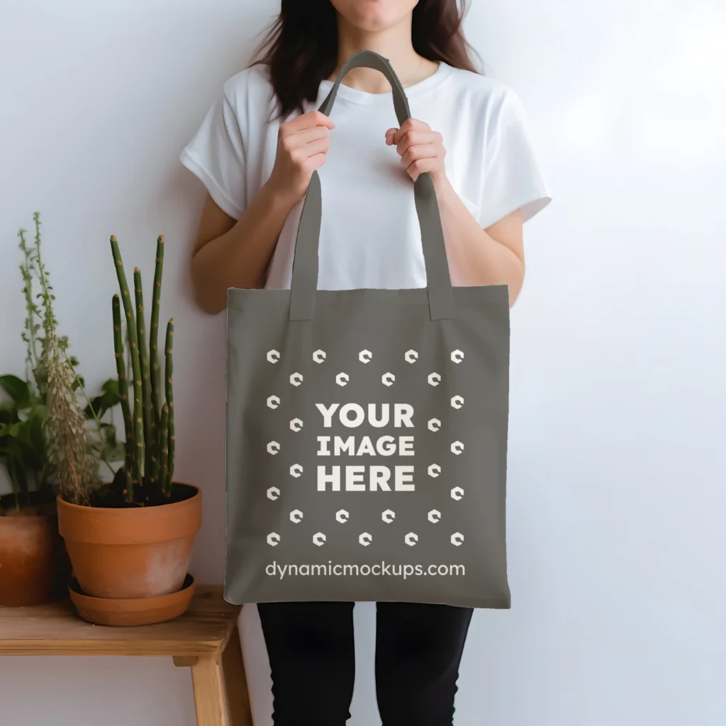 Woman Holding Dark Gray Tote Bag Mockup Front View Template