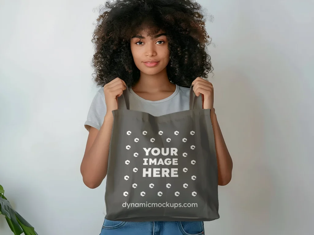 Woman Holding Dark Gray Tote Bag Mockup Front View Template