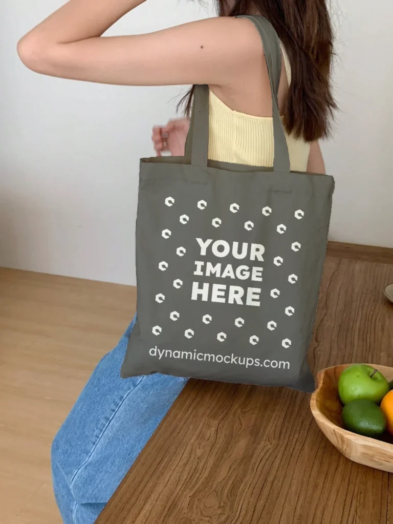 Woman Holding Dark Gray Tote Bag Mockup Side View Template