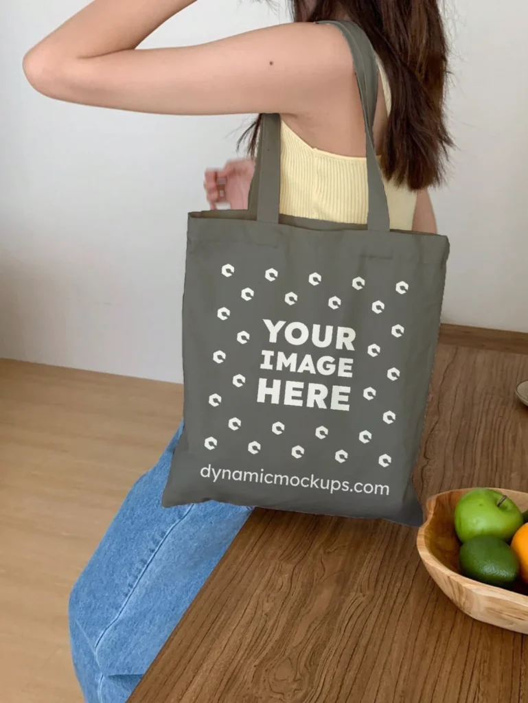 Woman Holding Dark Gray Tote Bag Mockup Side View Template