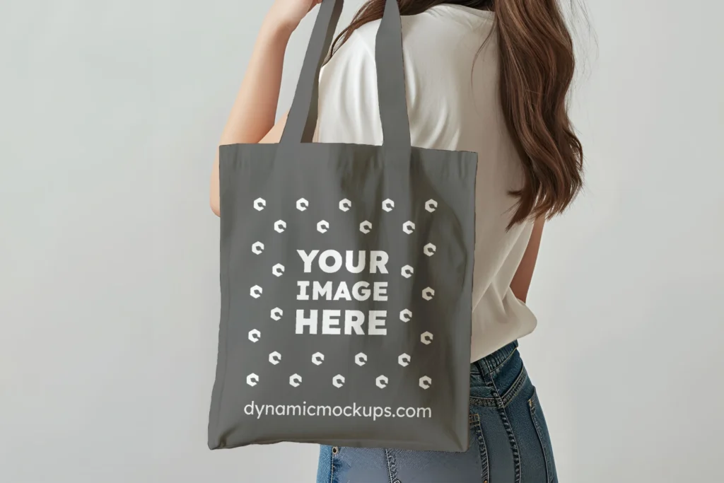 Woman Holding Dark Gray Tote Bag Mockup Side View Template