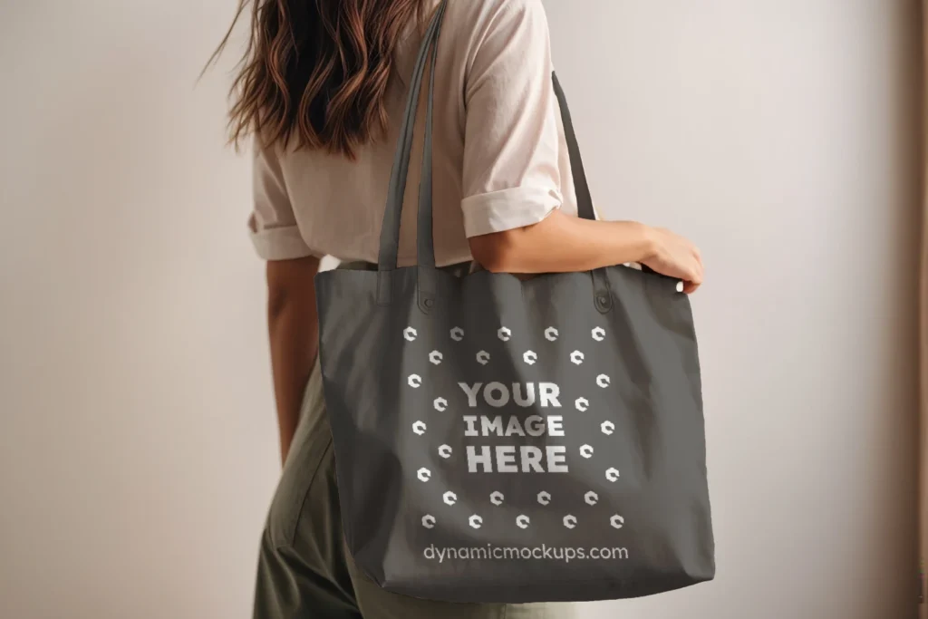 Woman Holding Dark Gray Tote Bag Mockup Side View Template