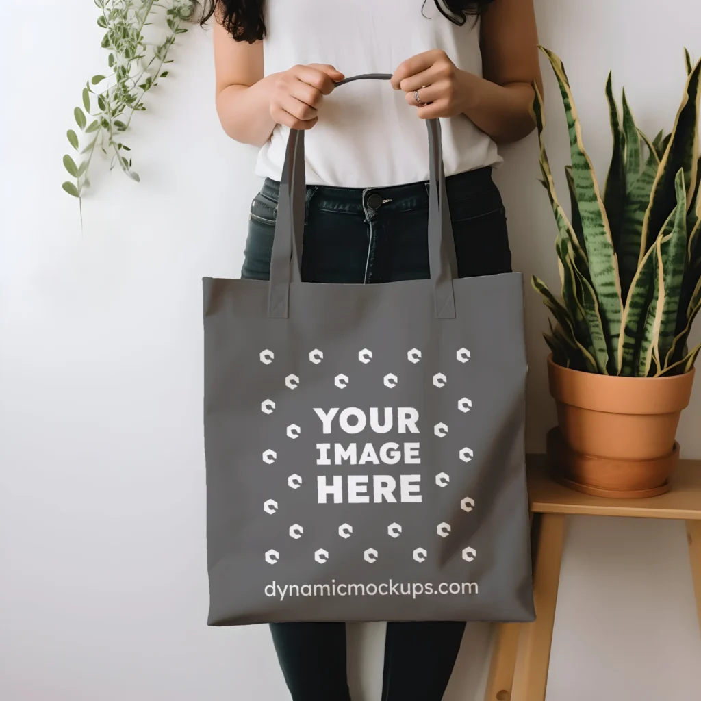 Woman Holding Dark Gray Tote Bag Mockup Front View Template