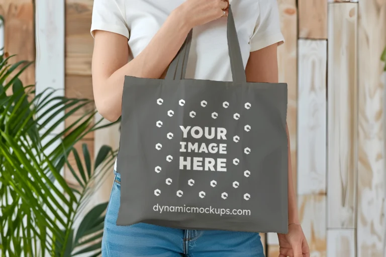 Woman Holding Dark Gray Tote Bag Mockup Front View Template