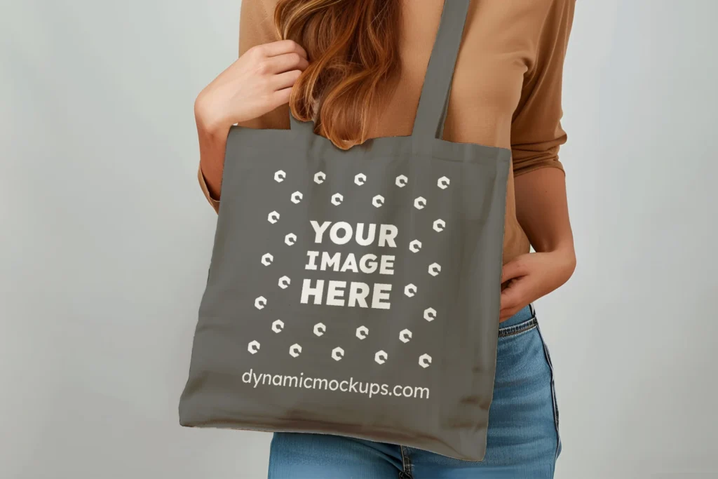 Woman Holding Dark Gray Tote Bag Mockup Front View Template