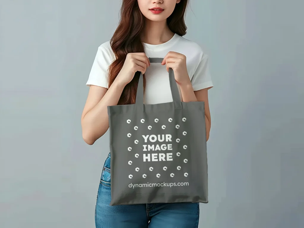 Woman Holding Dark Gray Tote Bag Mockup Front View Template