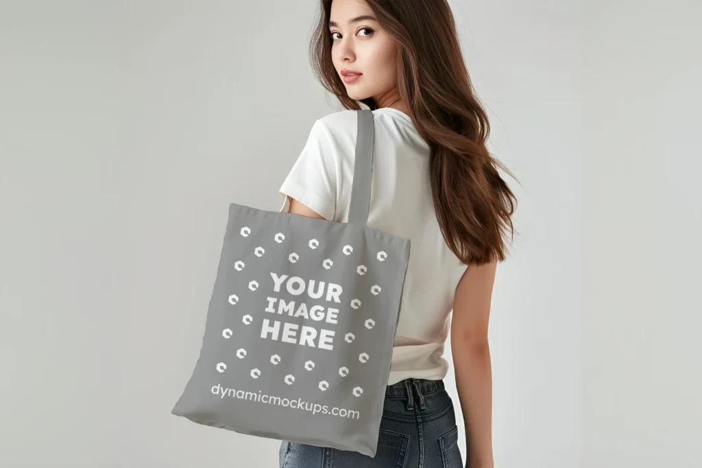 Woman Holding Gray Tote Bag Mockup Back View Template