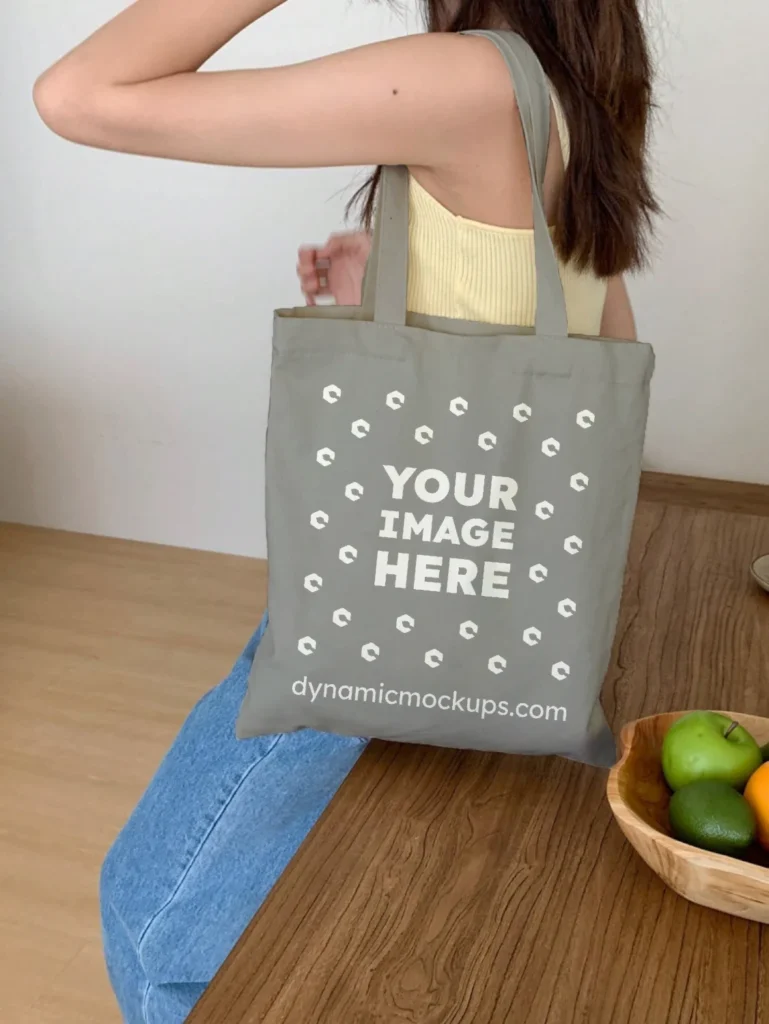 Woman Holding Gray Tote Bag Mockup Side View Template