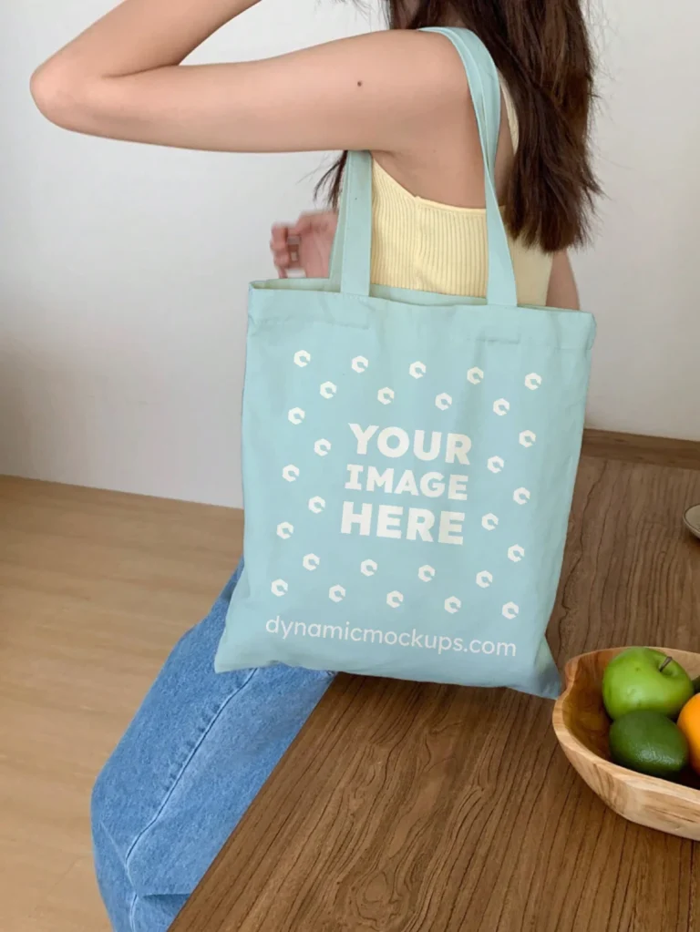 Woman Holding Light Blue Tote Bag Mockup Side View Template