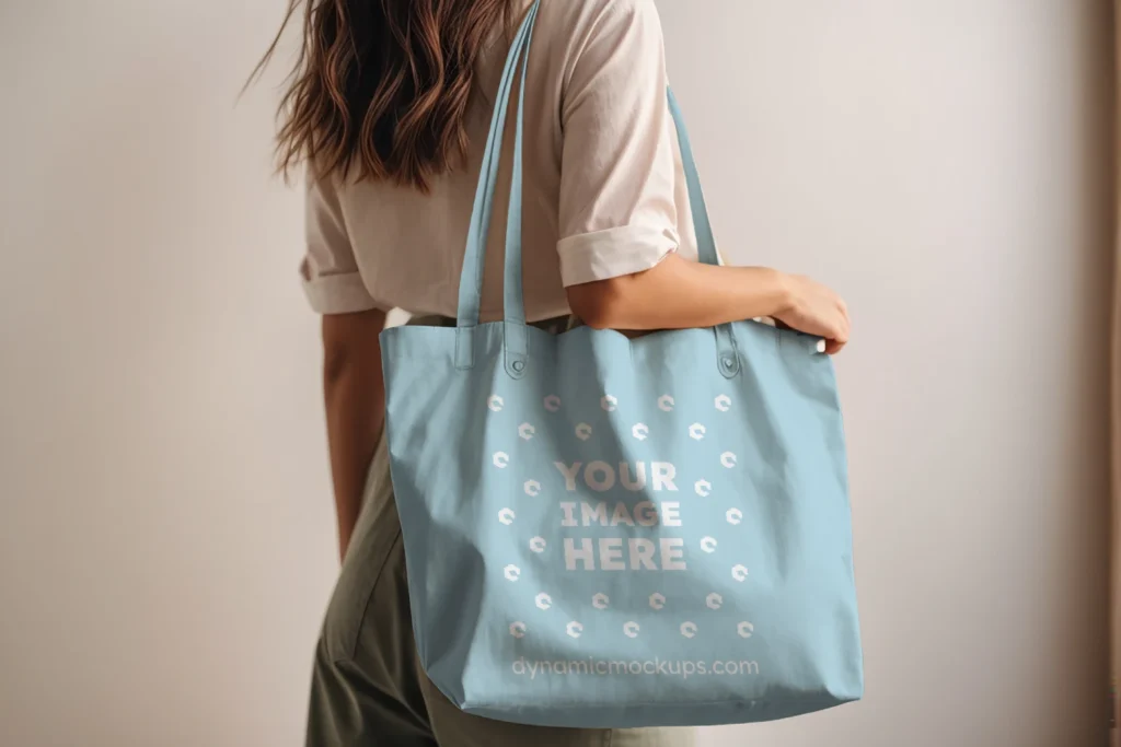 Woman Holding Light Blue Tote Bag Mockup Side View Template