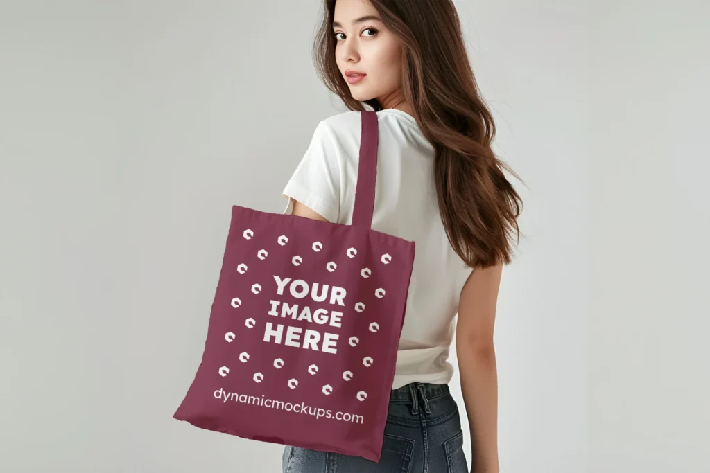 Woman Holding Maroon Tote Bag Mockup Back View Template