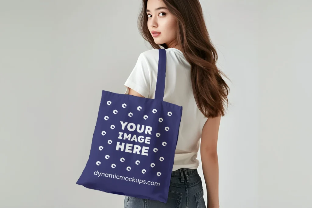 Woman Holding Navy Blue Tote Bag Mockup Back View Template