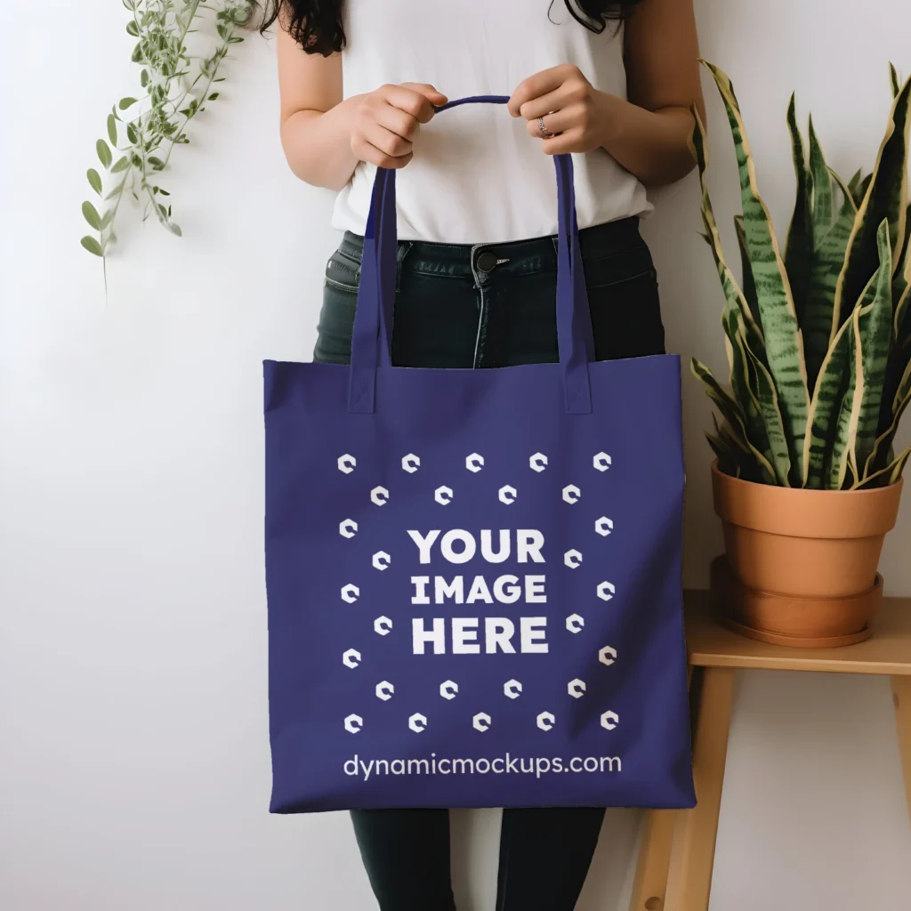 Woman Holding Navy Blue Tote Bag Mockup Front View Template