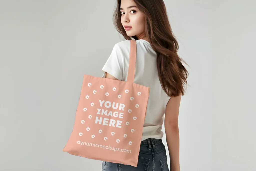 Woman Holding Peach Tote Bag Mockup Back View Template