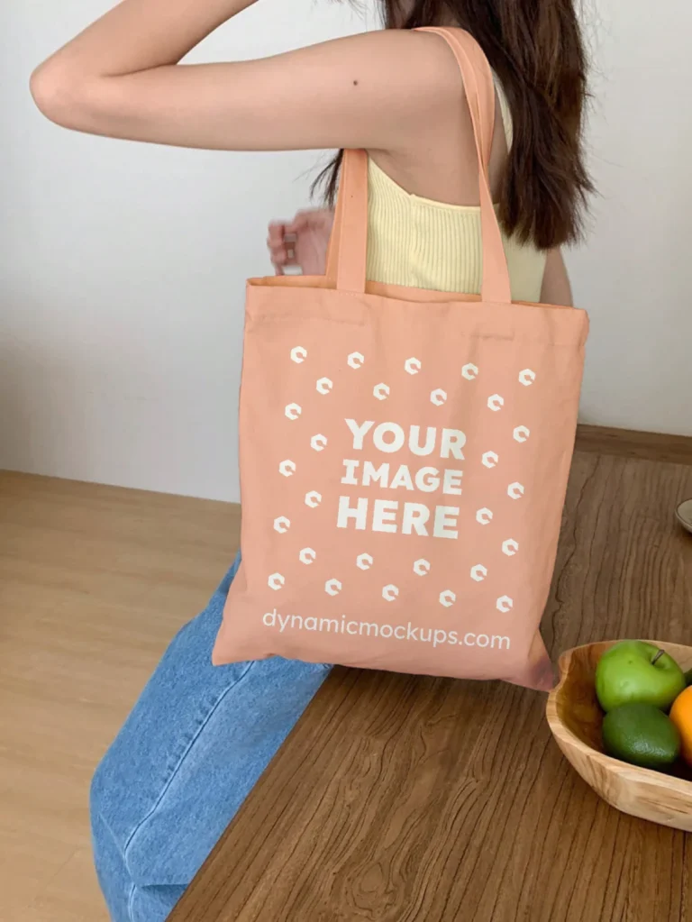 Woman Holding Peach Tote Bag Mockup Side View Template