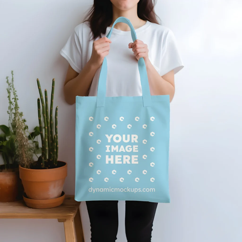 Woman Holding Sky Blue Tote Bag Mockup Front View Template