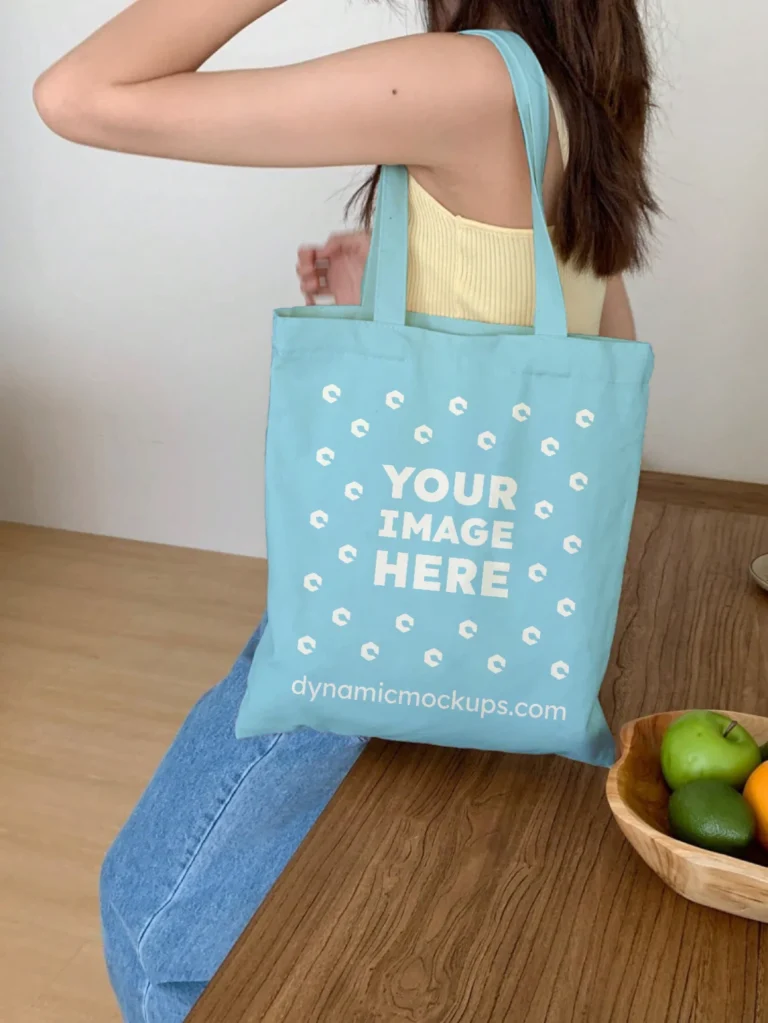 Woman Holding Sky Blue Tote Bag Mockup Side View Template