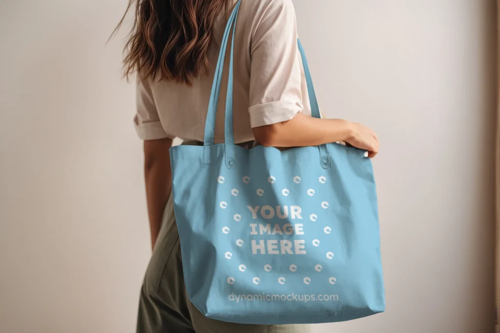 Woman Holding Sky Blue Tote Bag Mockup Side View Template