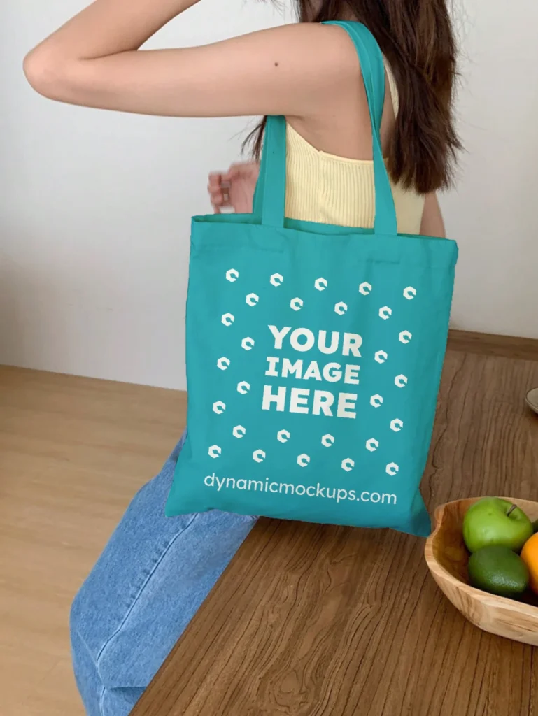 Woman Holding Teal Tote Bag Mockup Side View Template