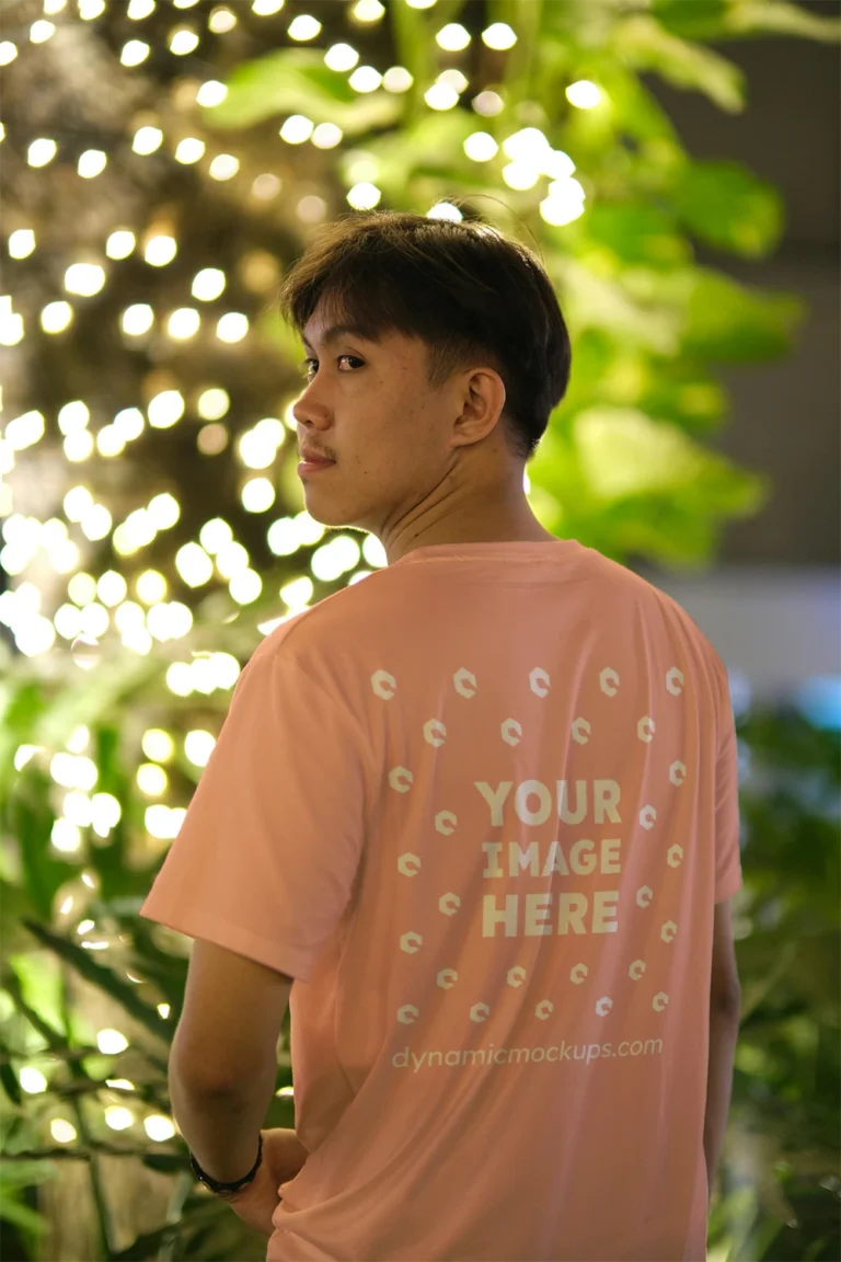 Man Wearing Peach T-shirt Mockup Back View Template