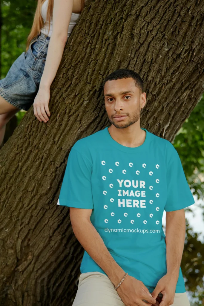 Man Wearing Teal T-shirt Mockup Front View Template