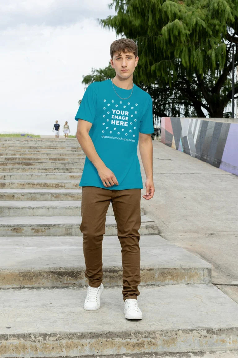 Man Wearing Teal T-shirt Mockup Front View Template