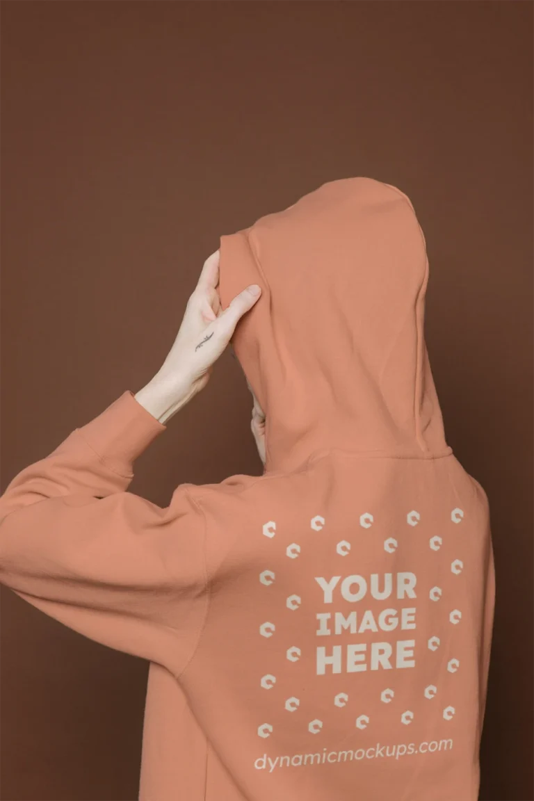 Woman Wearing Peach Hoodie Mockup Back View Template