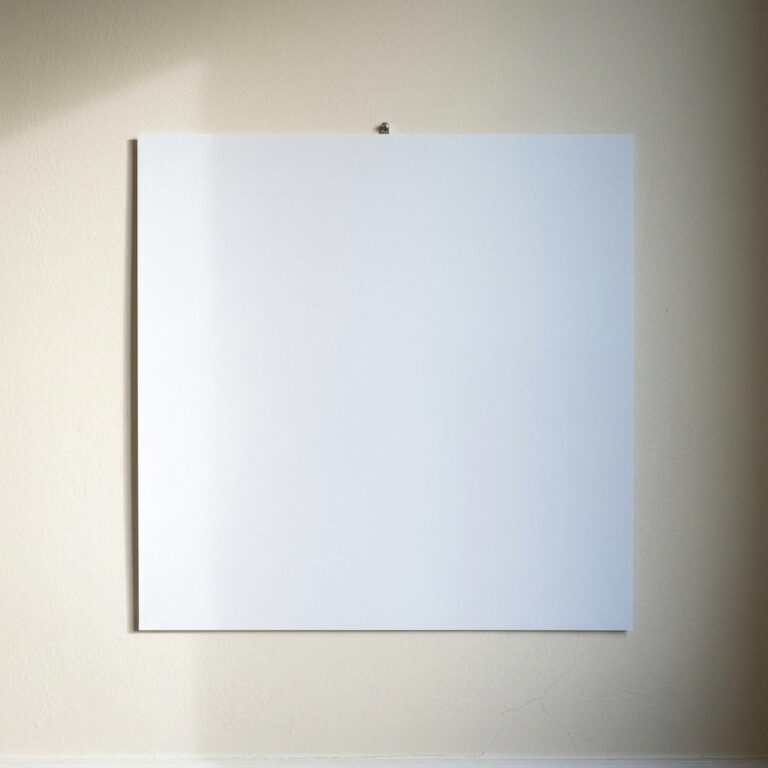 Free Square Poster Mockup on a Cream Plaster Wall
